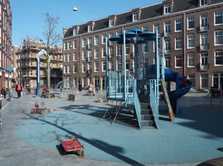 A completed playground in the space between buildings